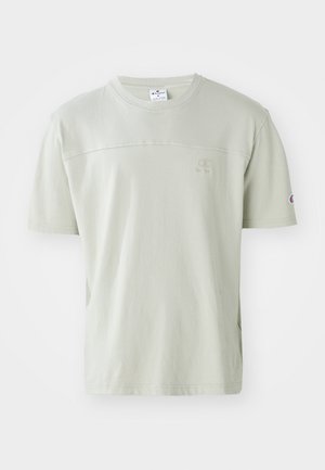 Hellgrünes T-Shirt mit kurzen Ärmeln aus Baumwolle. Mit einem Rundhalsausschnitt und einem dezenten Logo auf der Brust. Glatte Textur mit lockerer Passform.