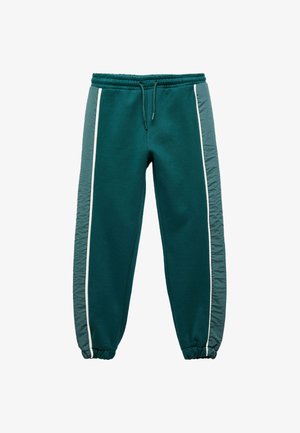 Türkise Sweatpants mit elastischem Bund, weißen Seitenstreifen und strukturierten grauen Stoffeinsätzen an den Seiten. Die Bündchen sind an den Knöcheln gerafft.