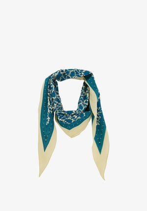 Écharpe triangulaire beige avec des motifs floraux bleus complexes et des motifs géométriques le long des bords, pliée en boucle lâche.