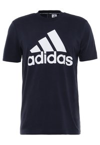 Námořnická modrá bavlněná tričko s velkým bílým logem "adidas" a designem tří pruhů na přední straně. Krátké rukávy a kulatý výstřih.