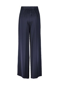 Granatowe spodnie o szerokich nogawkach, wykonane z gładkiego, lekkiego materiału, z elastycznym paskiem w talii oraz swobodnym, luźnym krojem.