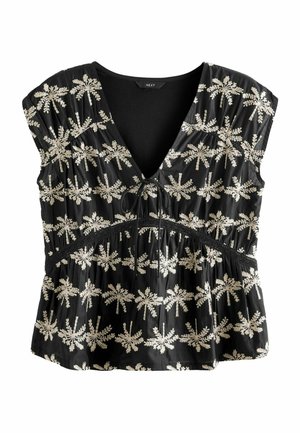 Blouse noire sans manches avec un profond col en V, broderie florale blanche, taille froncée et un petit lien central à l'encolure.