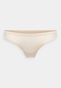 Beige thong underwear with a smooth fabric, minimalistic design, and a soft waistband featuring a subtle Calvin Klein logo.