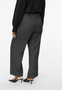 Gray wide-leg trousers with a smooth texture, featuring side pockets and a tailored fit, paired with black slingback heels.