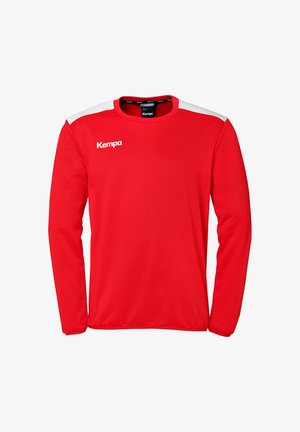 Rød langærmet sportsbluse lavet af åndbart stof, med hvide skulderdetaljer og et "Kempa" logo på forsiden.