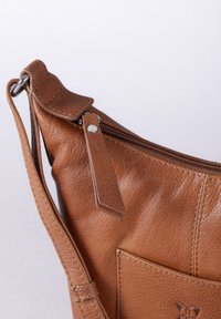 Brown leather shoulder bag with a textured finish, featuring a zippered closure and a front pocket with a small embossed logo.