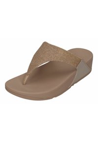 Kohver-kollased flip-flop sandaalid läikiva kuldse rihmaga. Pehme jalatugi ja madal vintske konts mugavuse ja toe tagamiseks.