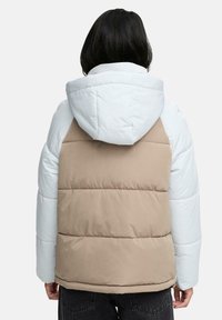 Vadderad jacka med en färgblockdesign som har ljusblå ärmar och en beige kropp, utrustad med huva och en strukturerad finish.