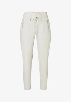 Light beige jogger pants with an elastic waistband, drawstring, and two side zip pockets. Smooth fabric with a tapered leg design.