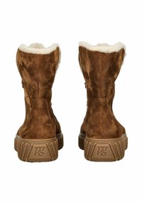 Bottines en suede marron avec une douce doublure en fausse fourrure blanche, dotées d'une semelle en caoutchouc texturée et d'un accent logo à l'arrière.