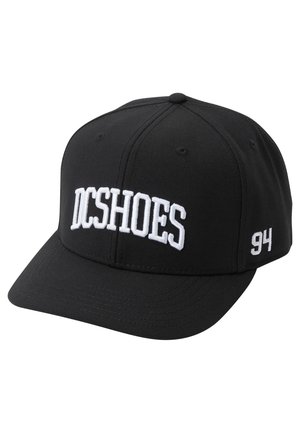 Black baseball cap made of fabric, featuring white embroidered "DCSHOES" logo on front and number "94" on the side. Flat brim design.