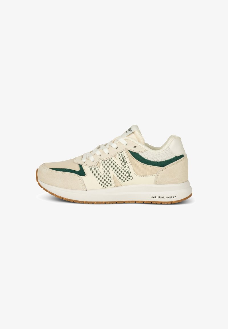 Beige athletic shoe with green accents, mesh panels, and a textured heel. Features white laces and a rubber sole, labeled "NATURAL SOFT™."