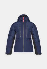 Navy puffer jacket with a hood, gray zippers, and red accents. Features two zippered chest pockets and side pockets with black sleeves.