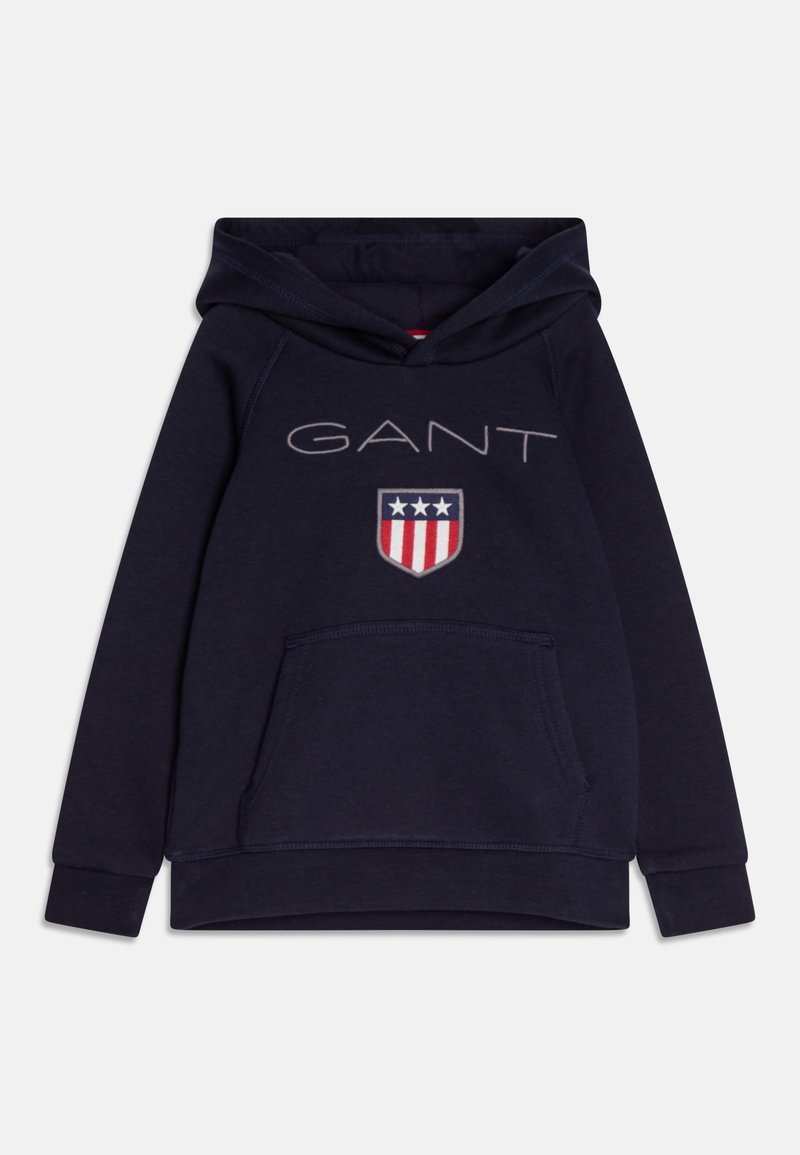 Felpa con cappuccio blu navy in cotone, con tasca frontale, cappuccio con coulisse, grande logo "GANT" e stemma a scudo con accenti rossi, bianchi e blu.