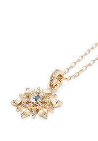 Guld vedh�ængs halskæde med stjernedesign, central klar sten, hvide accenter og mindre rhinestones. Fastgjort til en guld kæde.