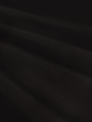 Black fabric with a smooth texture, featuring subtle ripples. The surface appears soft and matte, creating a uniform color without patterns.