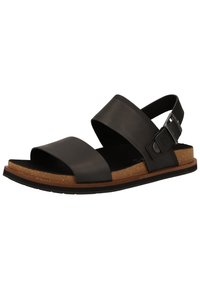 Sandales en cuir noir avec deux larges sangles, une semelle en liège et une semelle en caoutchouc. Comprend une sangle réglable avec une boucle en métal.