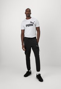Puma FLEX CARGO PANT - Pantalon de survêtement - black