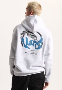 Felpa grigia con un grande graphic sul retro che presenta un serpente e la parola "Vans" in blu, realizzata in un materiale morbido, con tasca a canguro.