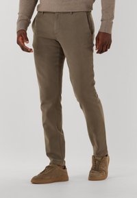 Khaki trousers featuring a slim fit, side pockets, and waistband with belt loops, paired with light brown suede sneakers.