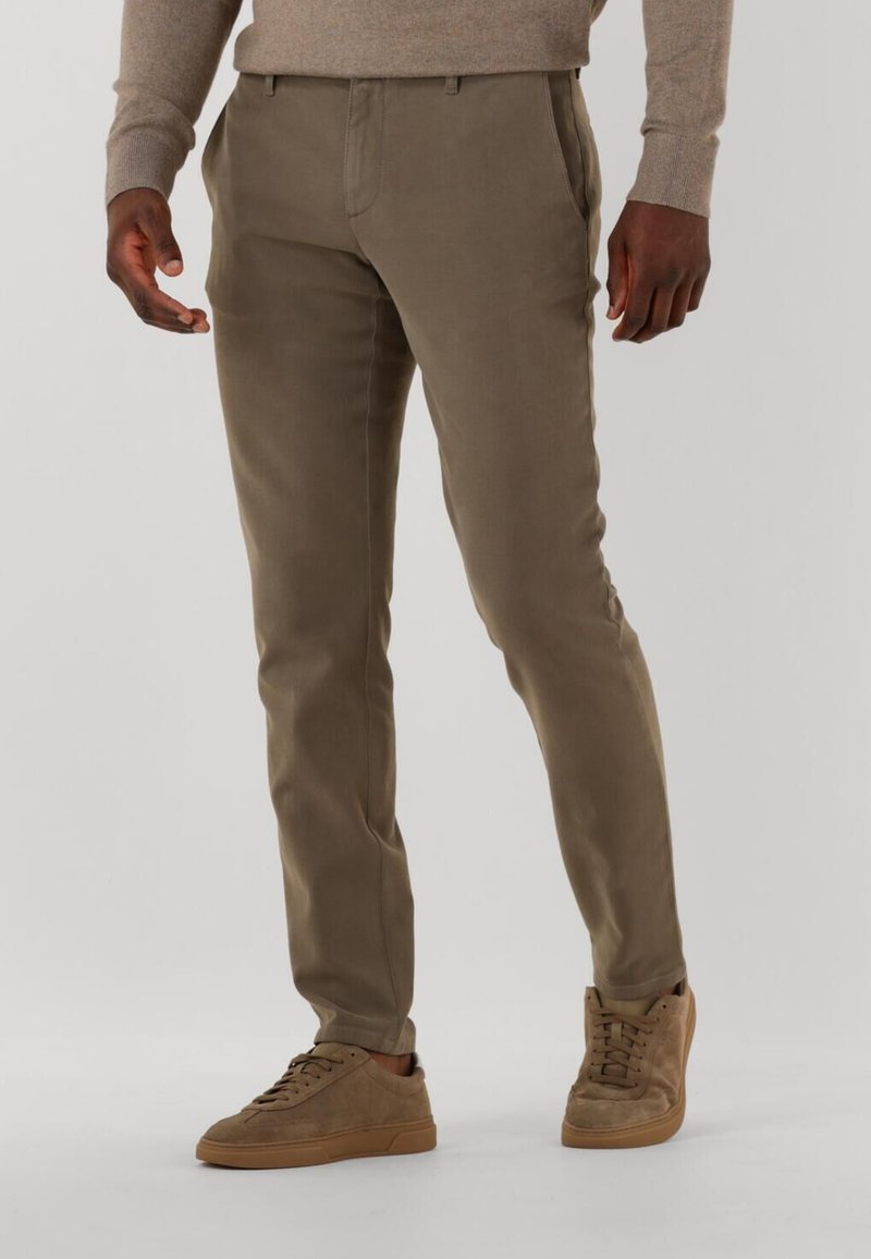 Khaki trousers featuring a slim fit, side pockets, and waistband with belt loops, paired with light brown suede sneakers.