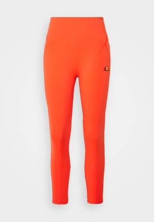 Leggings pleins orange vif taille haute avec un petit logo noir et orange sur la cuisse gauche supérieure.
