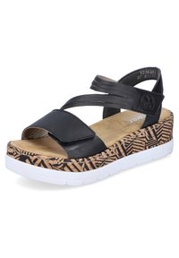 Schwarze Plattform-Sandalen mit überkreuzten Riemen, Kork-texturierte Zwischensohle mit geometrischen Mustern, gepolsterter Fußbett und weißer Gummisohle.