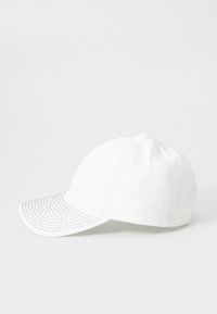White baseball cap made of fabric with a rounded crown and a curved brim, featuring a studded design on the brim's underside.