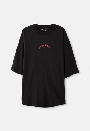 Black short-sleeve t-shirt made of cotton. Features a round neckline and red "palm angels" logo in an arched design on the front.