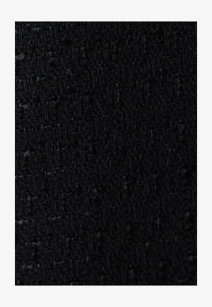 Geweven zwarte stof met een textuur, voorzien van een subtiele ruitpatroon, wat suggereert dat het een duurzaam en gestructureerd materiaal is.