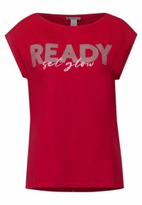 Röd bomullströja med korta ärmar. Har "READY" i randiga bokstäver och "get glow" i en kontrasterande stil nedan. Mjuk textur.