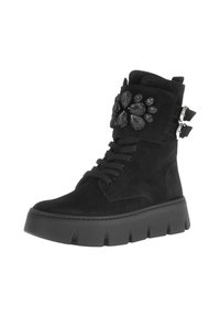 Black suede ankle boot with a chunky sole, decorative black jewels on the cuff, and dual side buckles. Features lace-up front design.