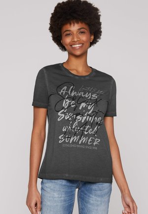 Dark gray cotton t-shirt with short sleeves. Front features white and black graphic text. Round neckline and relaxed fit with minimal detail.