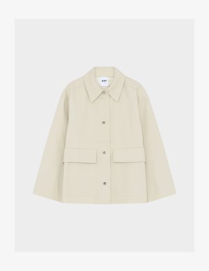 Chaqueta beige con botones, grandes bolsillos delanteros, cuello ancho y mangas largas, mostrada sobre un fondo blanco liso.