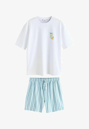 White short-sleeve t-shirt with a glass of lemon and an orange graphic, paired with blue and white vertical striped drawstring shorts.