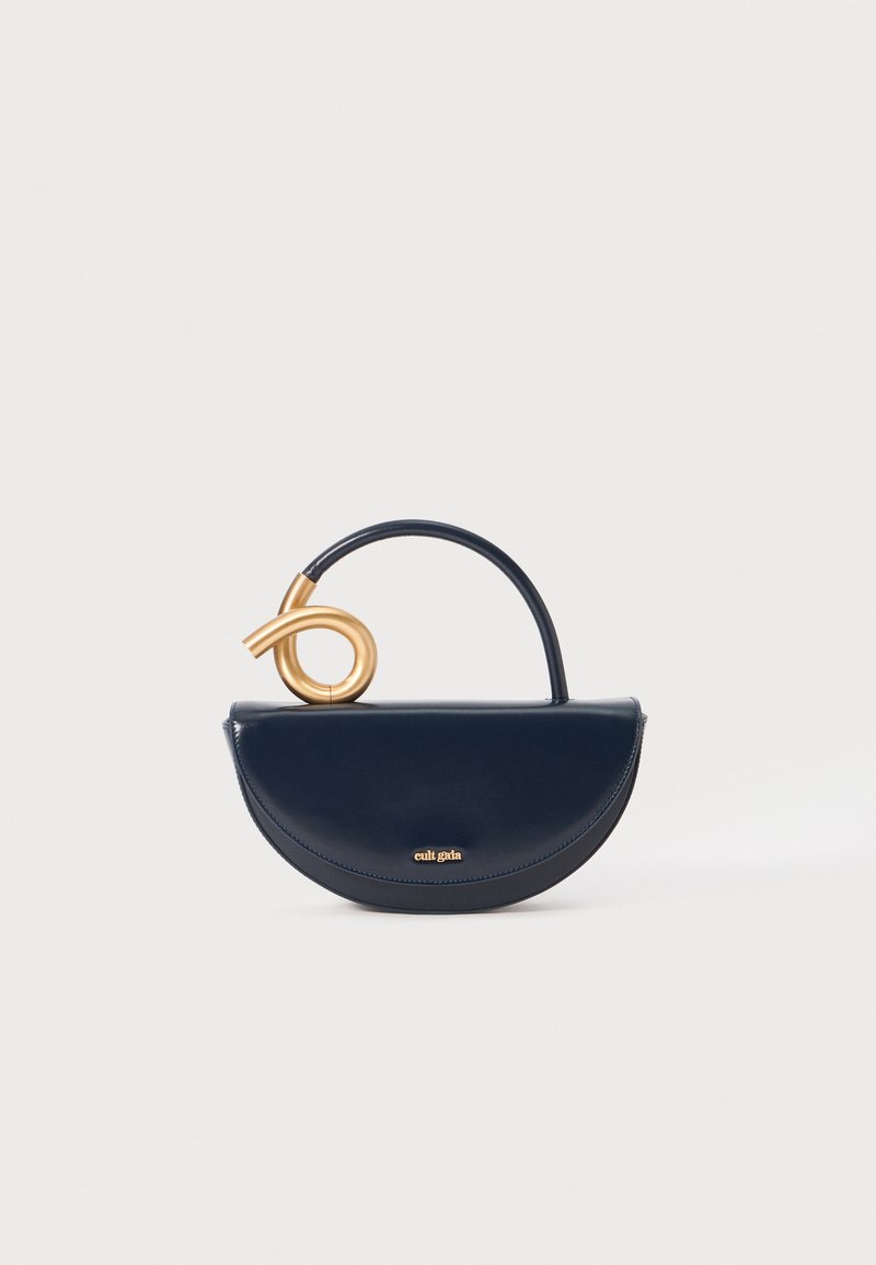 Navy leather handbag with a rounded design and a gold spiral handle. Features a subtle logo at the front and a smooth, glossy texture.