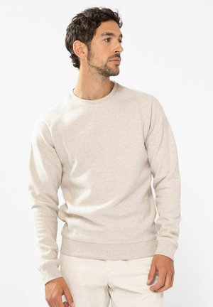 Beiger Rundhalsausschnitt-Pullover aus weichem Stoff mit langen Ärmeln sowie gerippten Bündchen und Saum. Minimalistisches Design mit lockerer Passform.