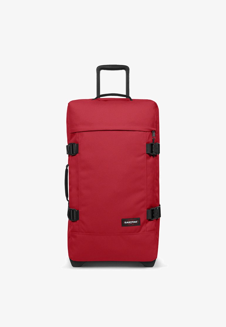 Red wheeled suitcase with a rectangular design, made of durable fabric, featuring black hardware, side buckles, and a telescoping handle.
