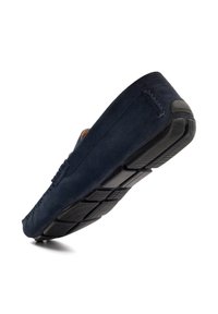 Navy suede moccasin-style shoe with rubber sole, stitched detailing, and a flexible design. Focus on comfort and casual wear suitability.