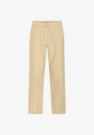 Beige lõdvestatud lõikega püksid, millel on elastne talje ja string, valmistatud pehmest materjalist, sirgete jalgadega ja ilma lisakaunistusteta.