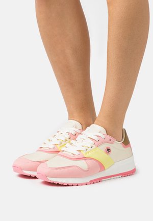 Multicolored sneakers featuring pink and yellow accents, fabric and suede materials, rounded toe, and white laces with a logo on the side.