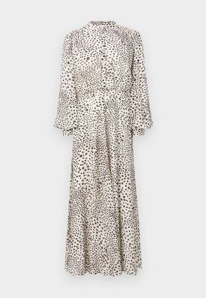 Ilga, sagutis priekyje su permatoma audinio medžiaga, šviesaus kremiško pagrindo su rudais taškeliais. Suknelė turi aukštą apykaklę ir pūstus ilgus rankovus, laisvai krentančius iki apačios.