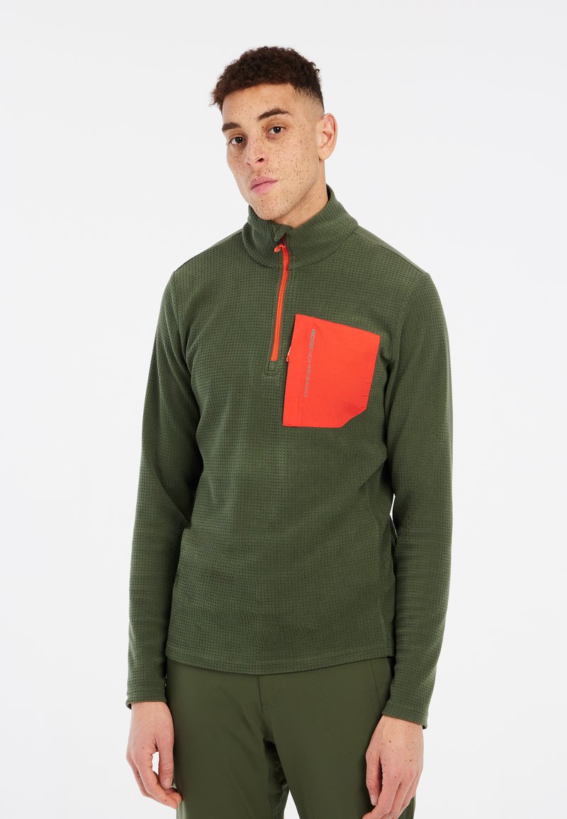Groene kwart-rits pullover van textuurstof met een contrasterende oranje borstzak. Bevat een hoge kraag en lange mouwen.