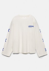 White long-sleeve shirt with blue "LIBERATE" text on chest and blue stars running down both sleeves.