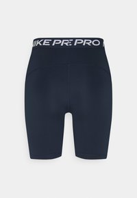 Shorts de sport noirs Nike Pro taille haute avec ceinture élastique et marquage blanc Nike Pro à l’arrière de la ceinture.