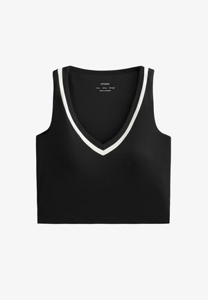 Top court noir sans manches avec un décolleté en V profond, présentant une bordure contrastante blanche autour de l'encolure. Étiquette de la marque visible au centre.
