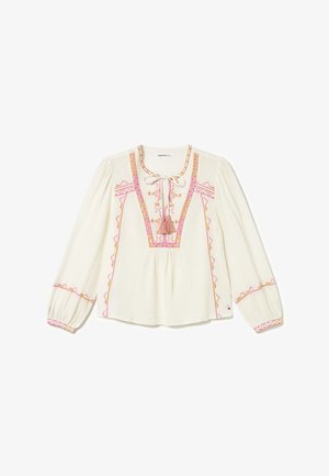 Blouse longue à manches longues de couleur blanc cassé avec broderies roses et orangées, lien à pampilles au niveau de l'encolure, manches et taille froncées.