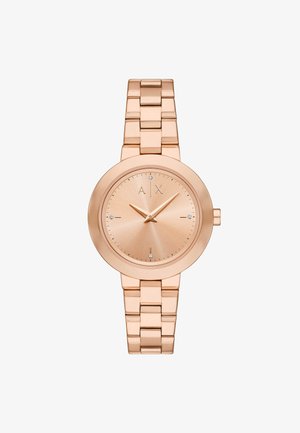 Relógio de metal cor de rosa com face redonda, design minimalista, mostrador refletor de luz e bracelete ligado. Apresenta sutis acentos de diamante.