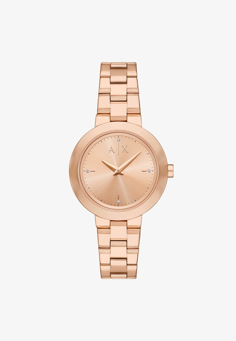 Rožnato zlato kovinsko uro z okroglo obliko, minimalističnim dizajnom, svetlobno odbojnim številčnico in povezanimi zapestnicami. Opremljena je z diskretnimi diamanti.