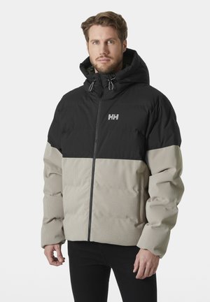 Padded jacket z czarną górną częścią i beżową dolną częścią, z kapturem, suwakiem z przodu i teksturowanym materiałem dla izolacji.